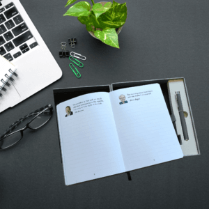 Open investing notebook on a desk beside a laptop and glasses