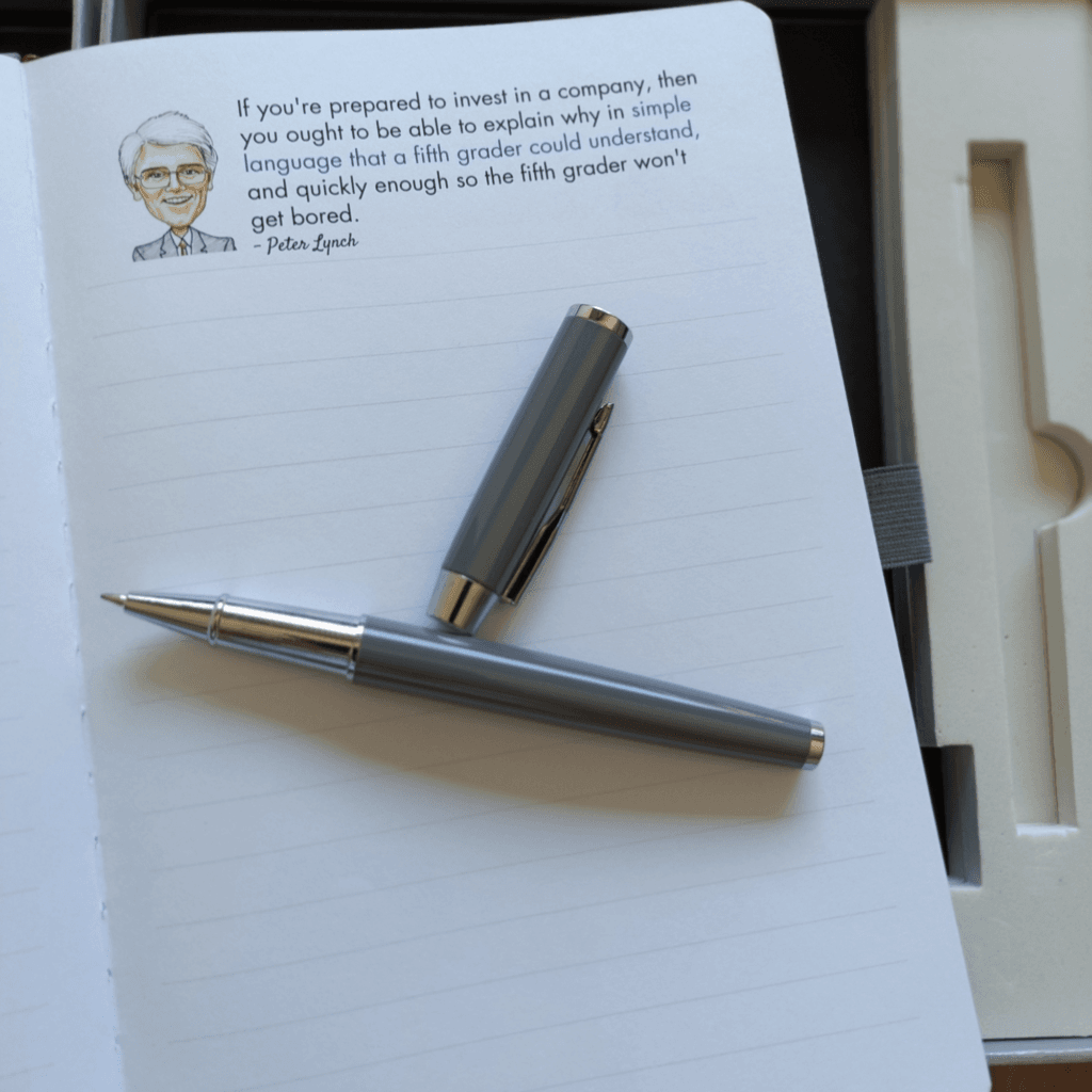 Open Notebook of Wisdom page with an investing quote and a pen