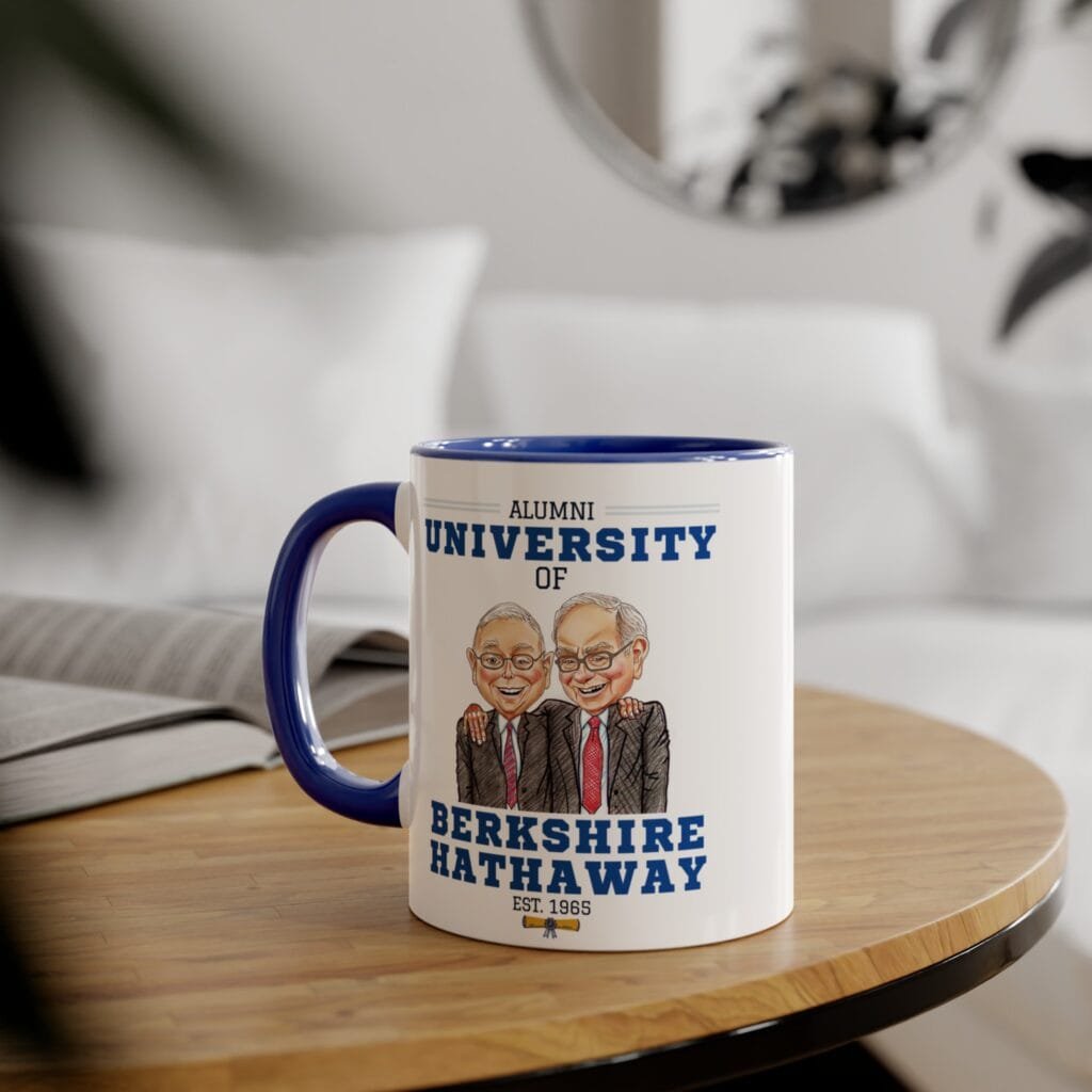 University of Berkshire Hathaway mug with Warren Buffett and Charlie Munger caricature, on a wooden side table