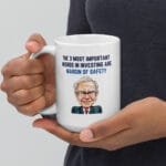 Hands holding Warren Buffett margin of safety quote mug: 'The 3 most important words in investing are margin of safety'