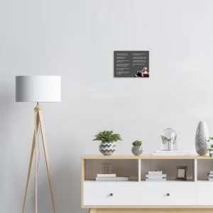 Charlie Munger canvas above a white sideboard with a floor lamp