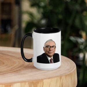 Minimalist charlie munger quote mug styled with books and workspace setup